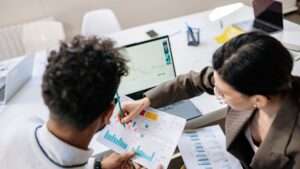 2 people reviewing project reports